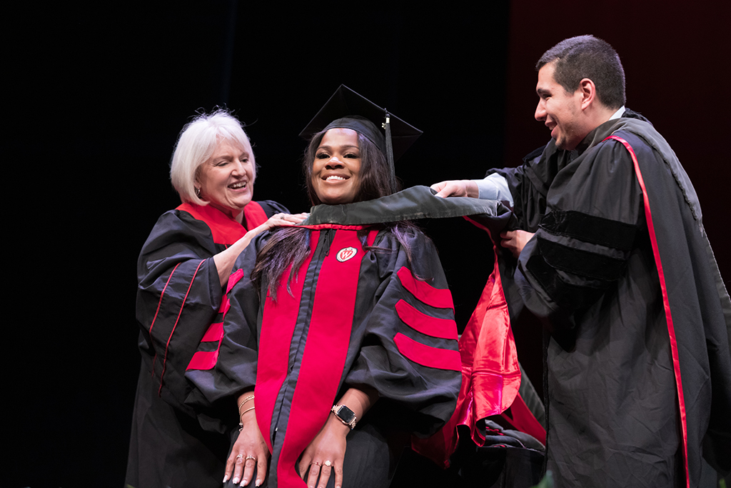 Class of 2022 PharmD graduate Silvya Velez Pache receives her hood from Professors Bonnie Fingerhut and Ed Portillo