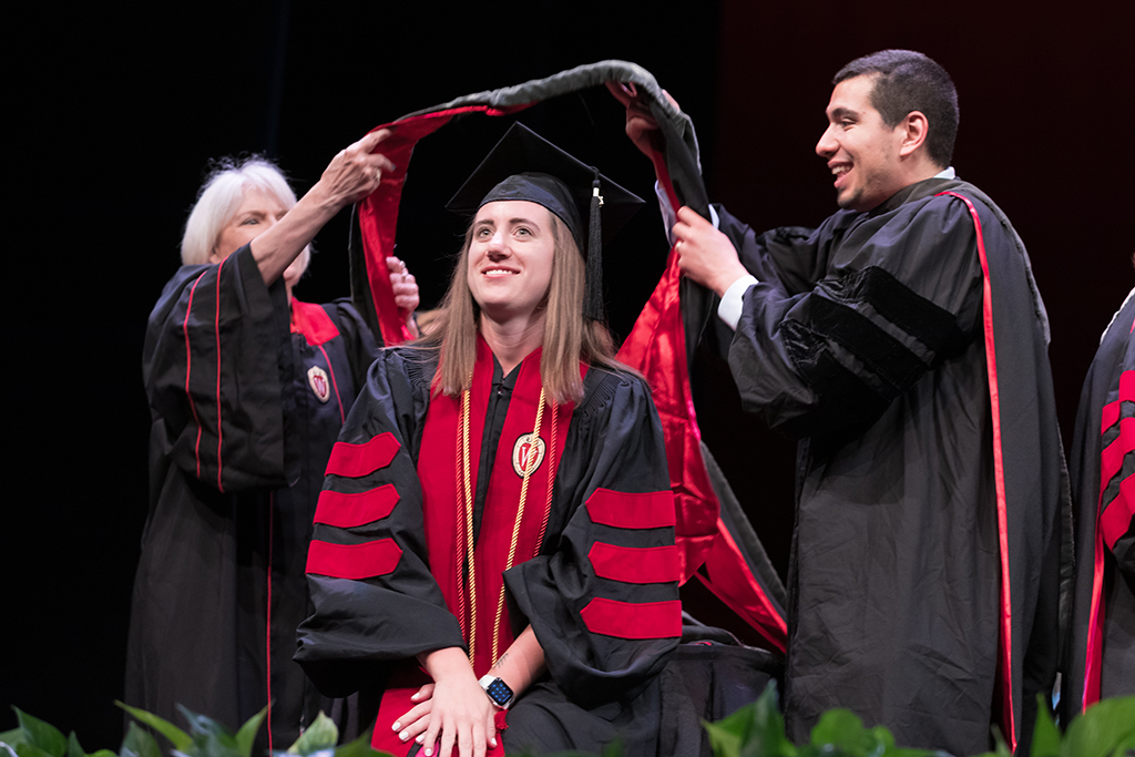 Class of 2022 PharmD graduate Andrea Wagner receives her hood from Professors Bonnie Fingerhut and Ed Portillo