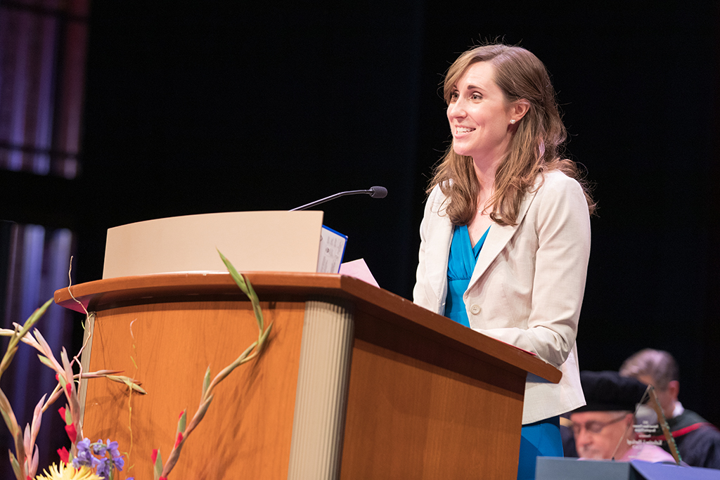 Kate Hartkopf speaking at podium for 2022 SoP Hooding ceremony