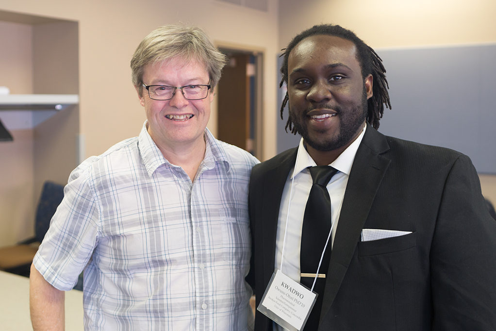 Chuck Lauhon standing with Kwadwo Owusu-Ofori.