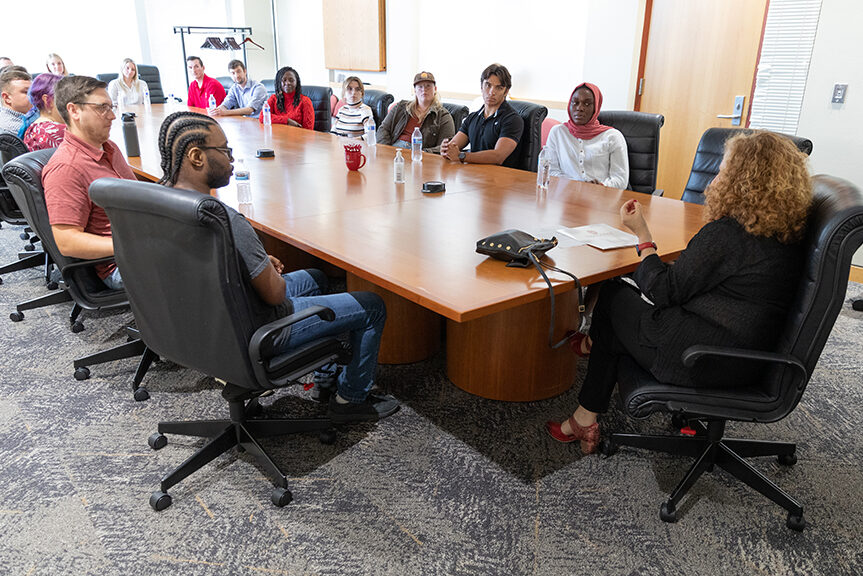 Chancellor Mnookin talking with staff in a conference room