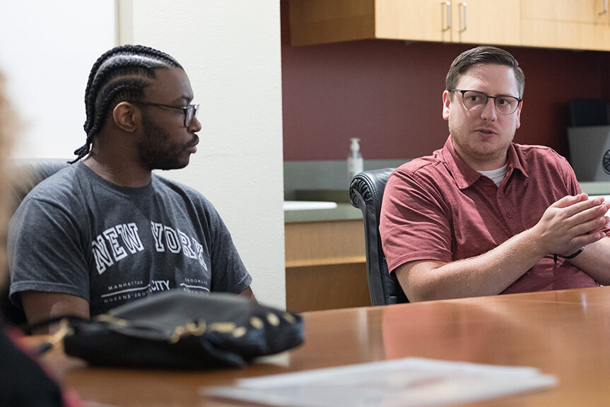 Staff members talking with Chancellor Mnookin in a conference room