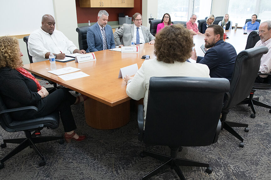 Chancellor Mnookin talking with staff in a conference room