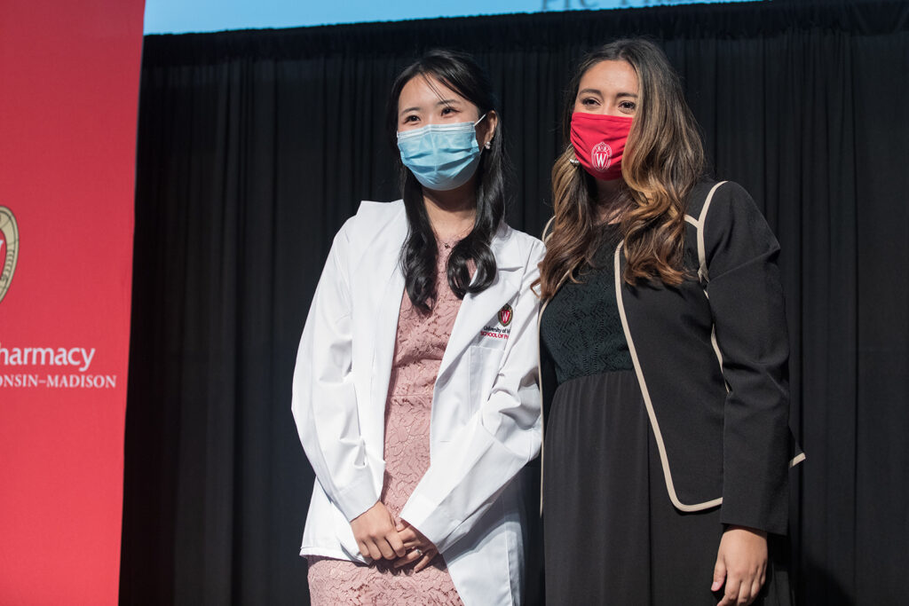 Student wearing their white coat on-stage