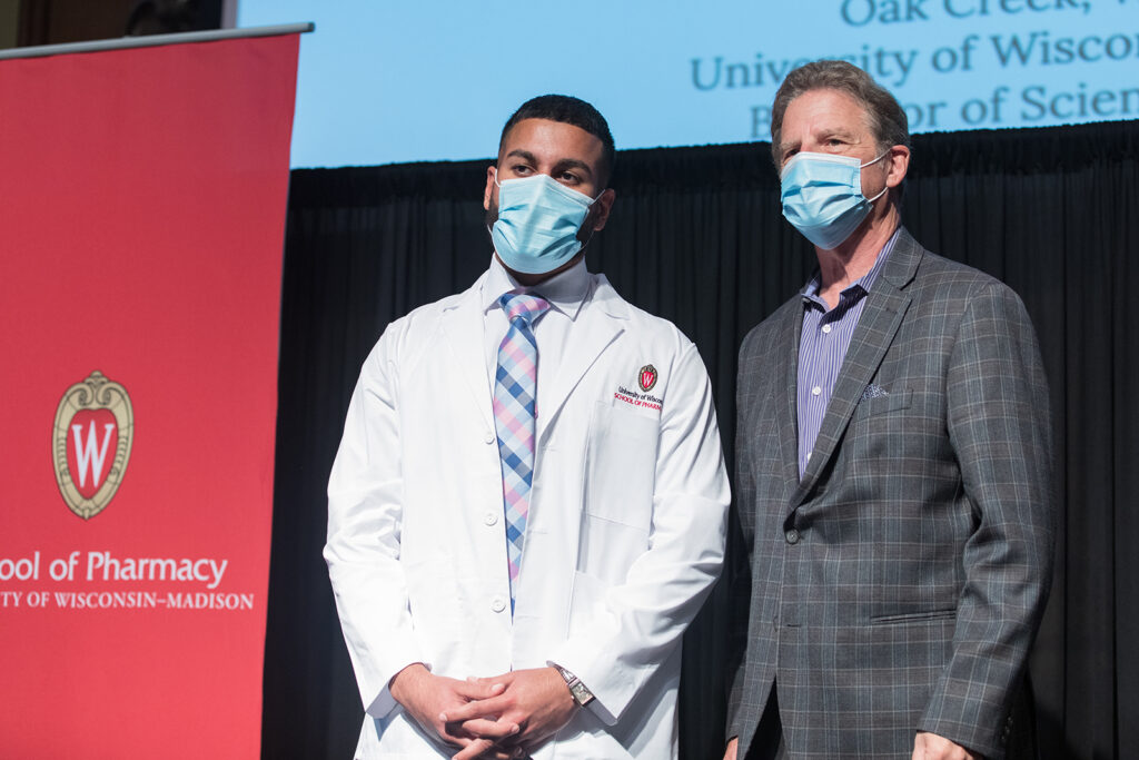Student wearing their white coat on-stage