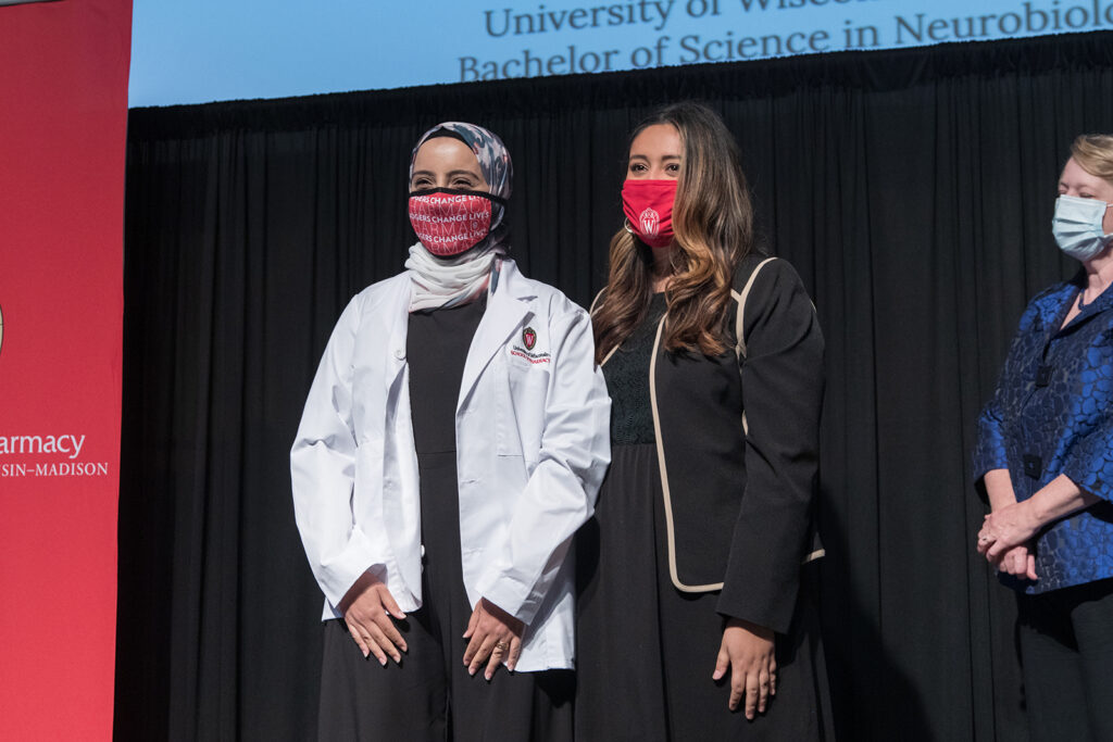 Student wearing their white coat on-stage