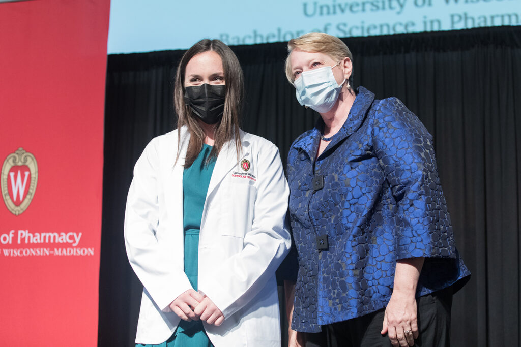 Student wearing their white coat on-stage