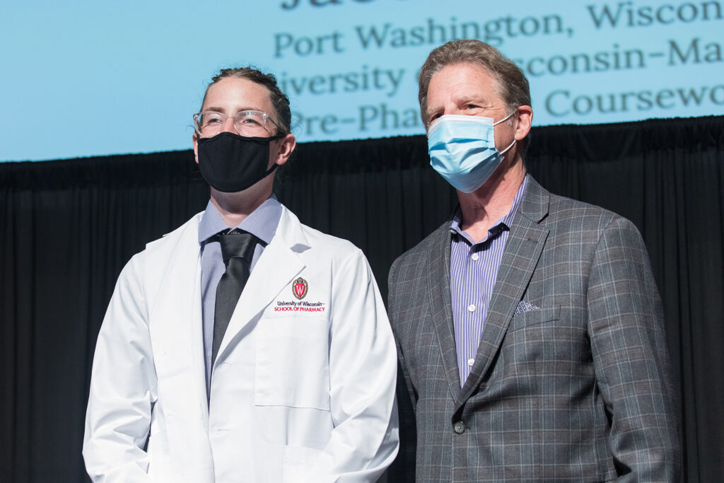 Student wearing their white coat on-stage