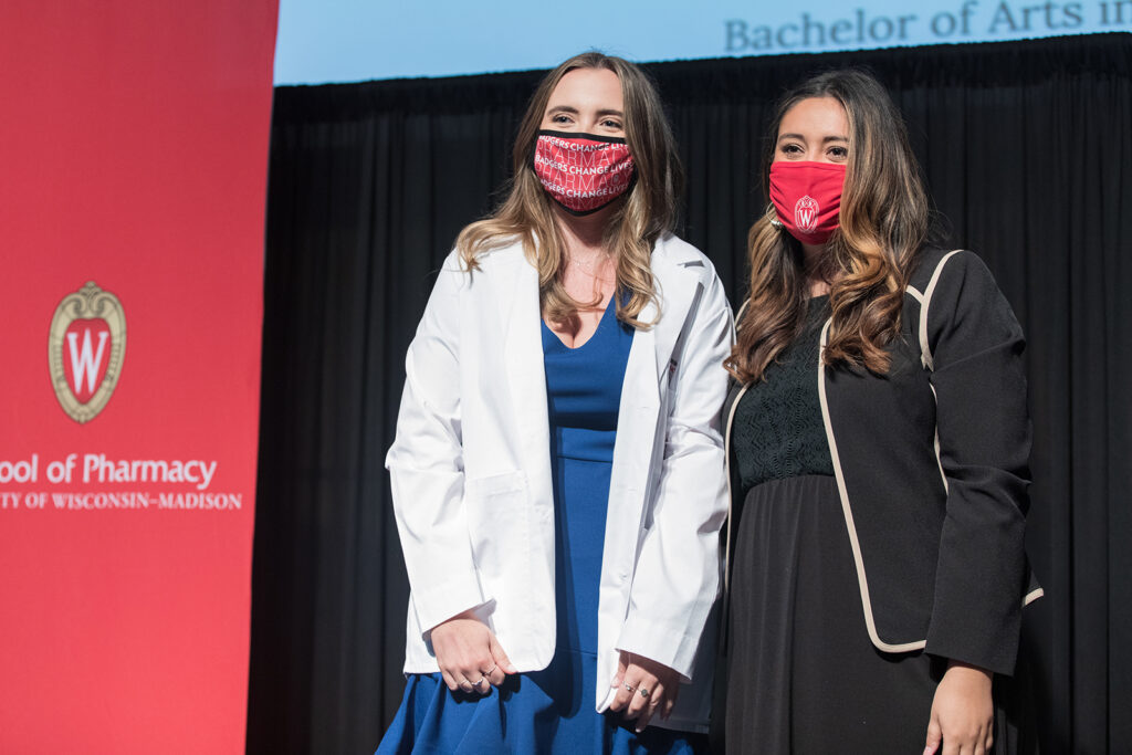 Student wearing their white coat on-stage