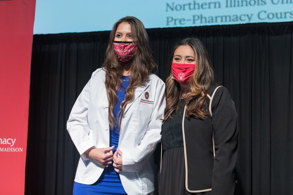 Student wearing their white coat on-stage