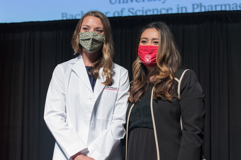 Student wearing their white coat on-stage