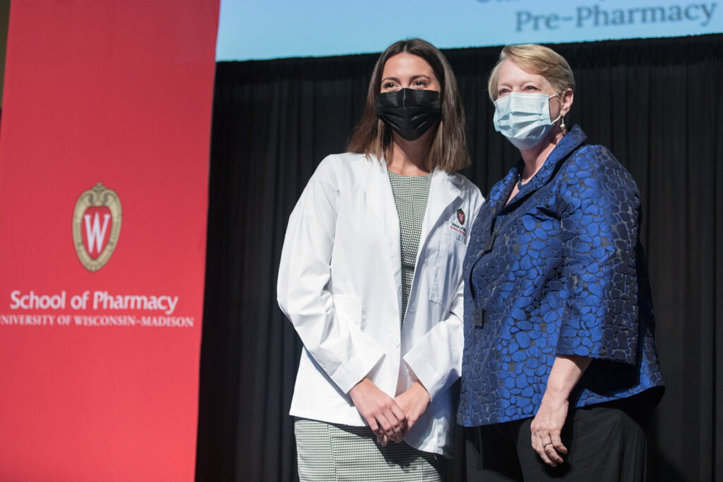 Student wearing their white coat on-stage