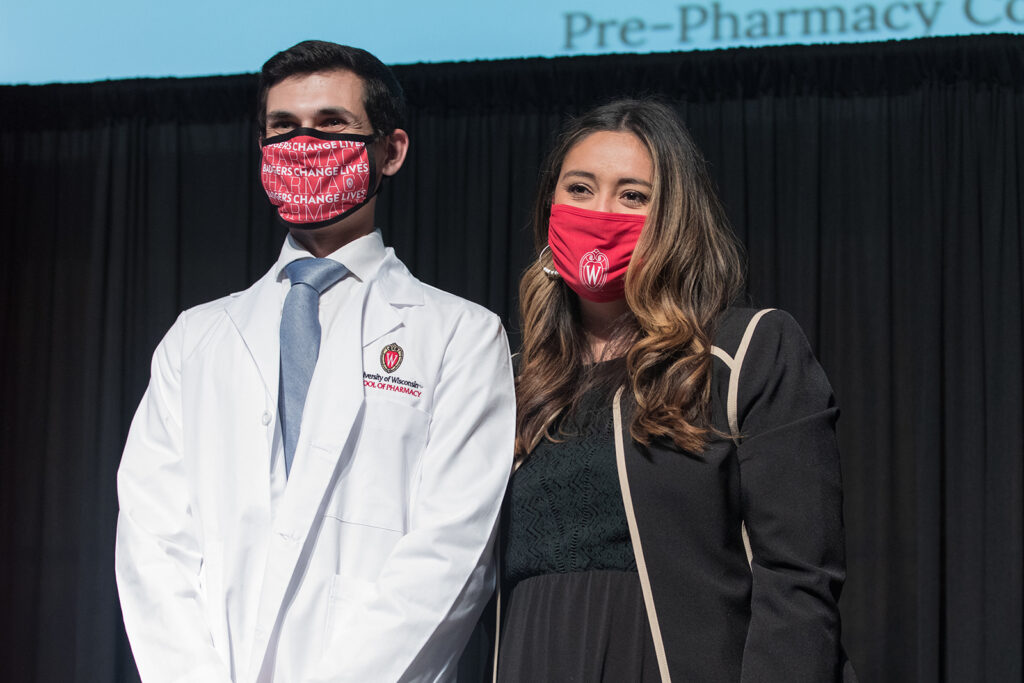 Student wearing their white coat on-stage