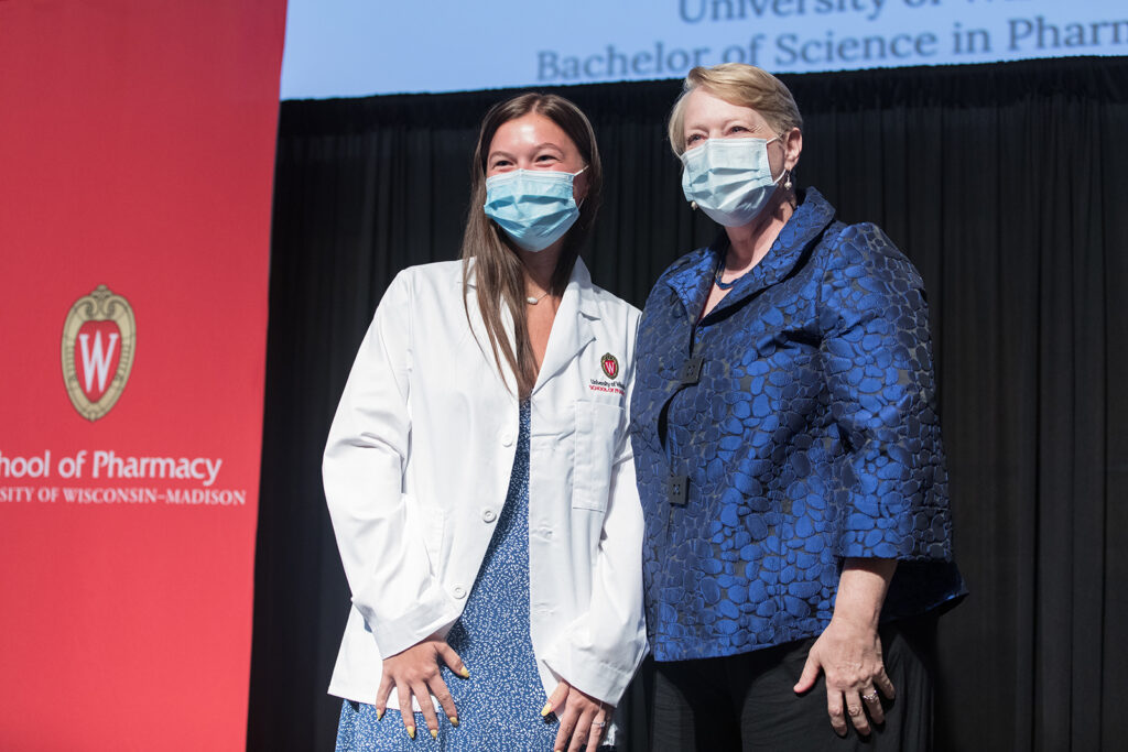 Student wearing their white coat on-stage