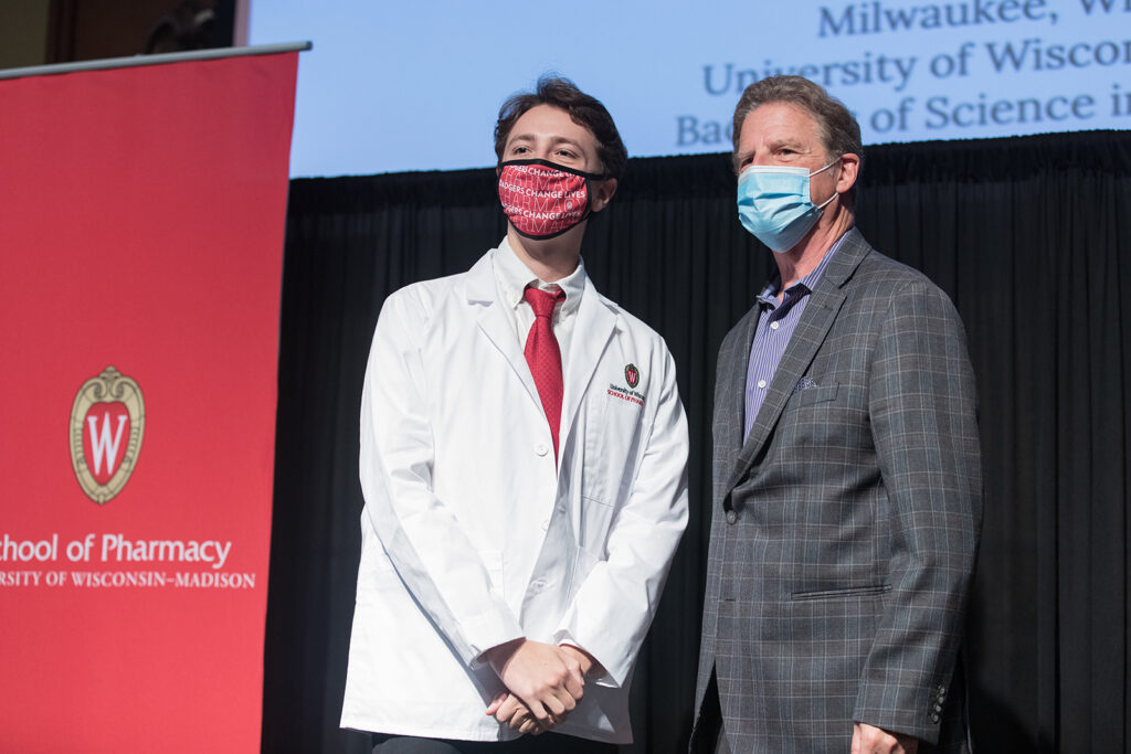 Student wearing their white coat on-stage