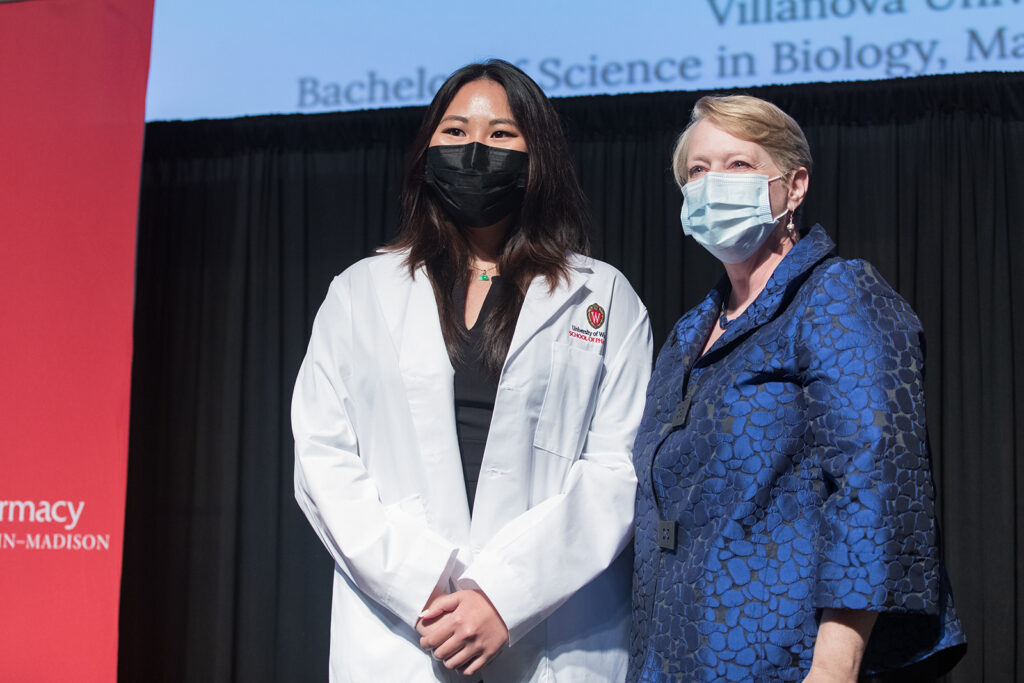 Student wearing their white coat on-stage