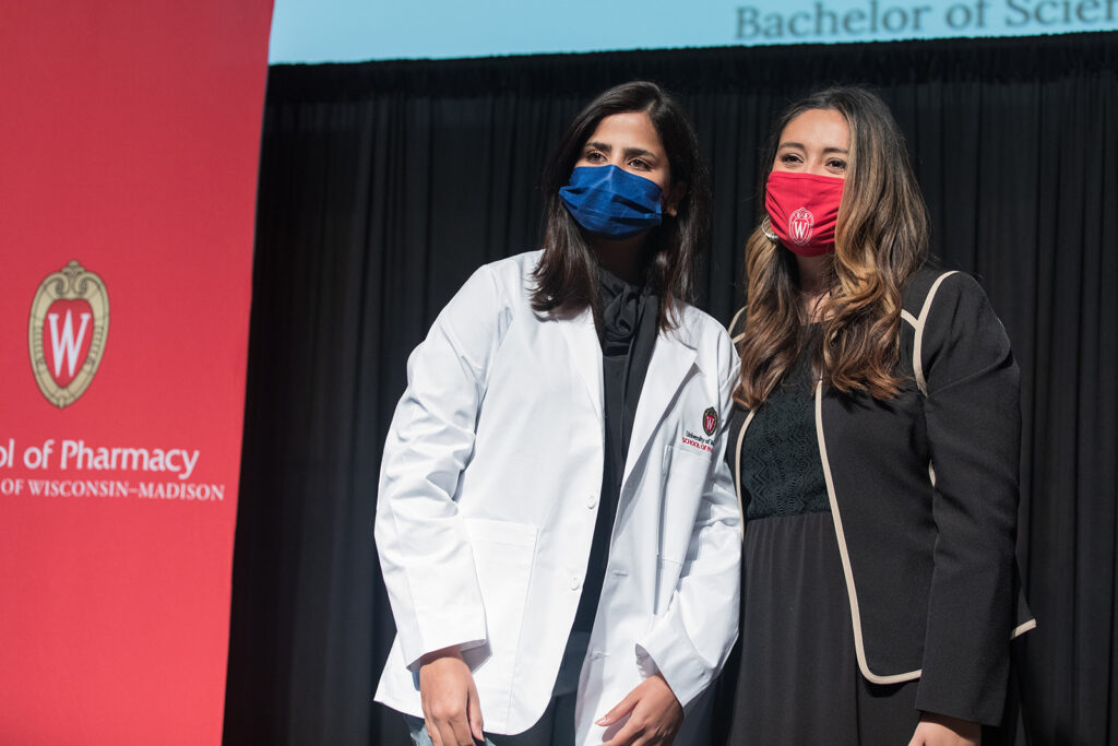 Student wearing their white coat on-stage