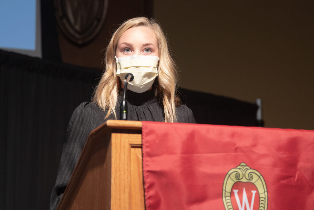 Speaker at podium for white coat ceremony