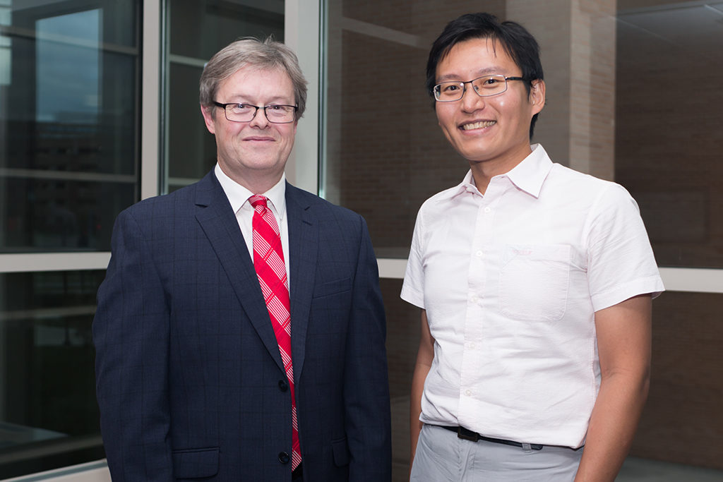 Chuck Lauhon standing with graduate student award recipient