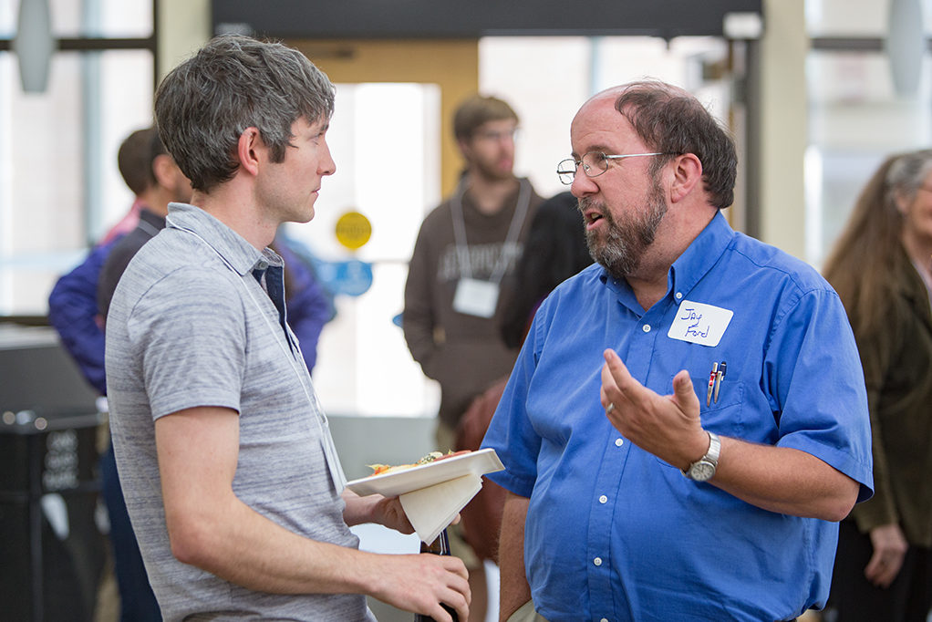 Jay Ford speaking with an associate