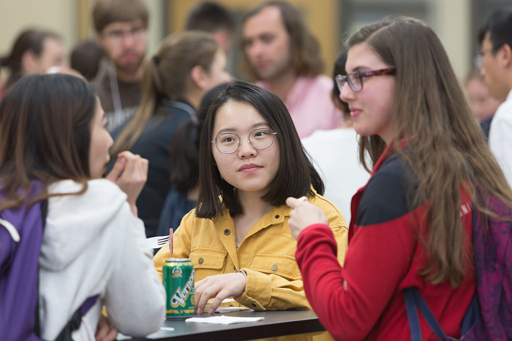 Students sitting around tables