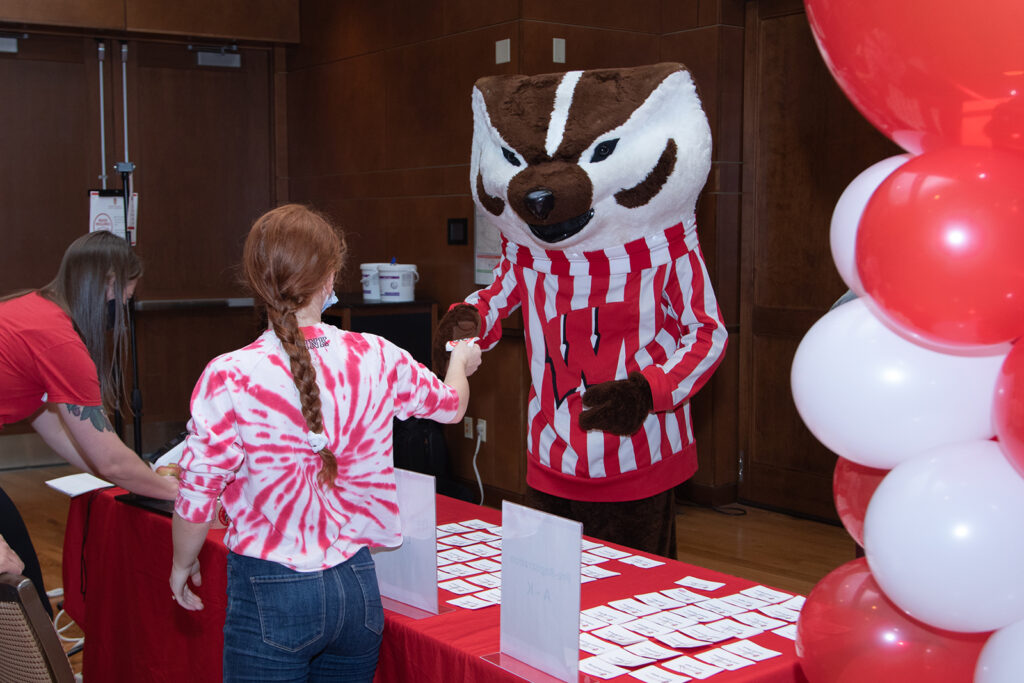 Bucky handing out name tags at event