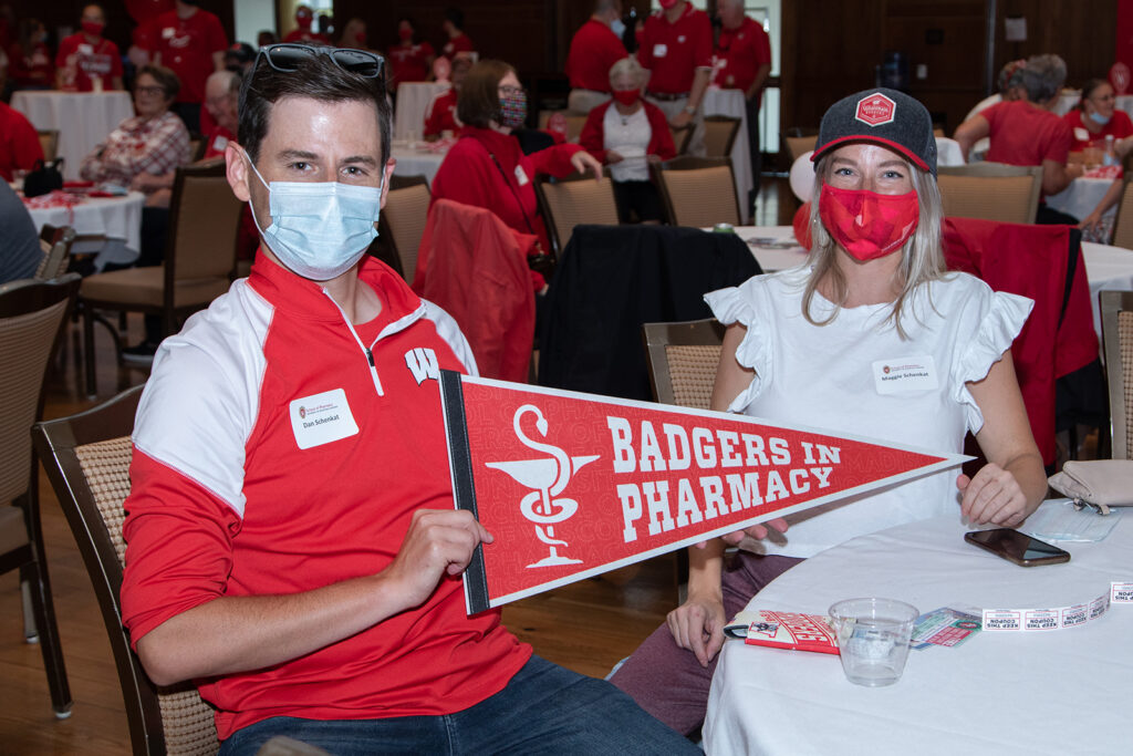 Alumni sitting at table with badger merch