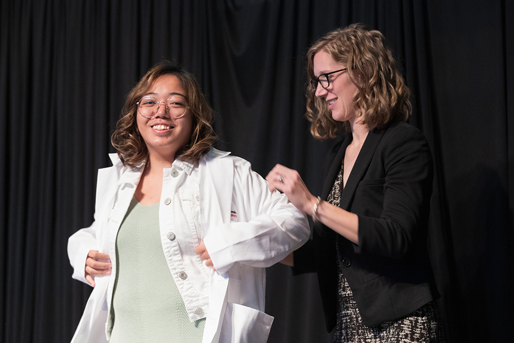 A student receives a white coat during the 2022 White Coat Ceremony.