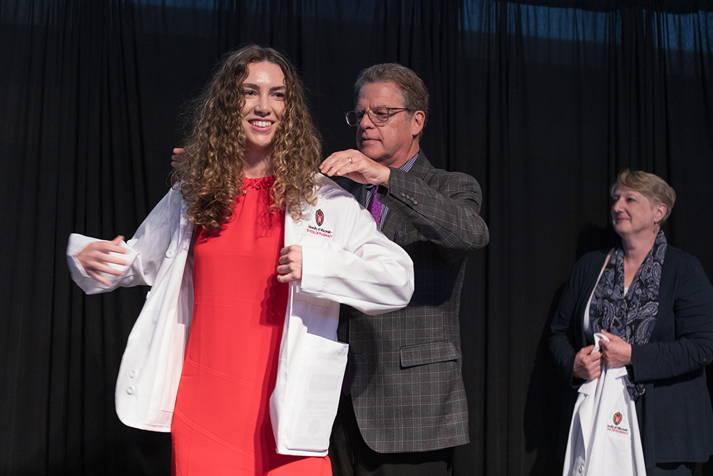 A student receives a white coat during the 2022 White Coat Ceremony.