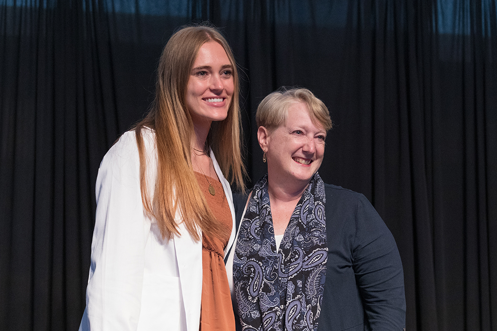 A student receives a white coat during the 2022 White Coat Ceremony.