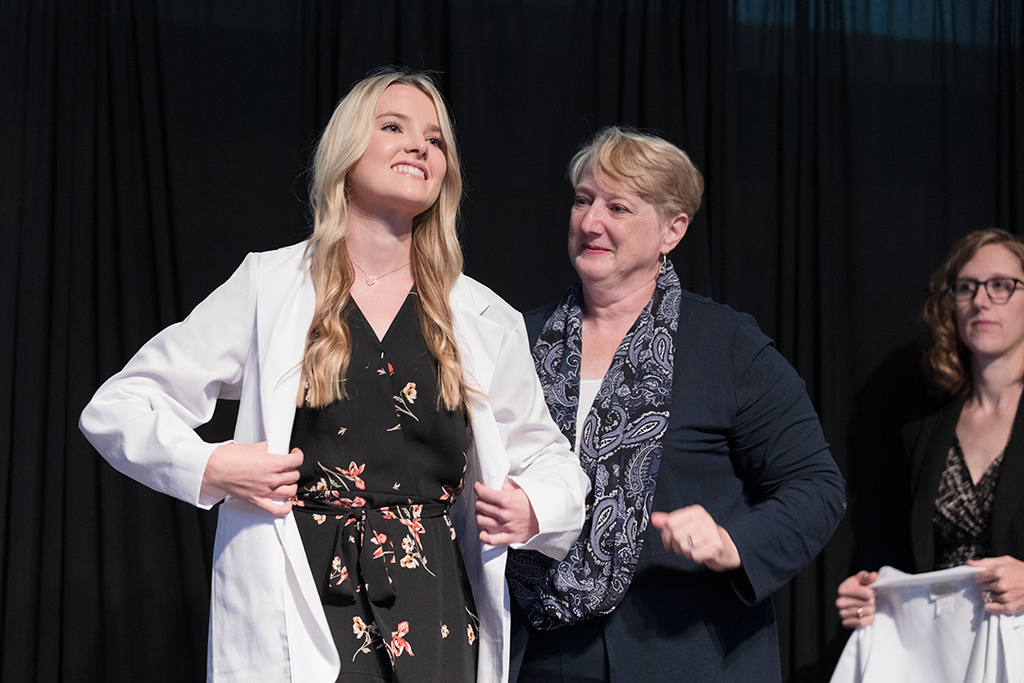 A student receives a white coat during the 2022 White Coat Ceremony.