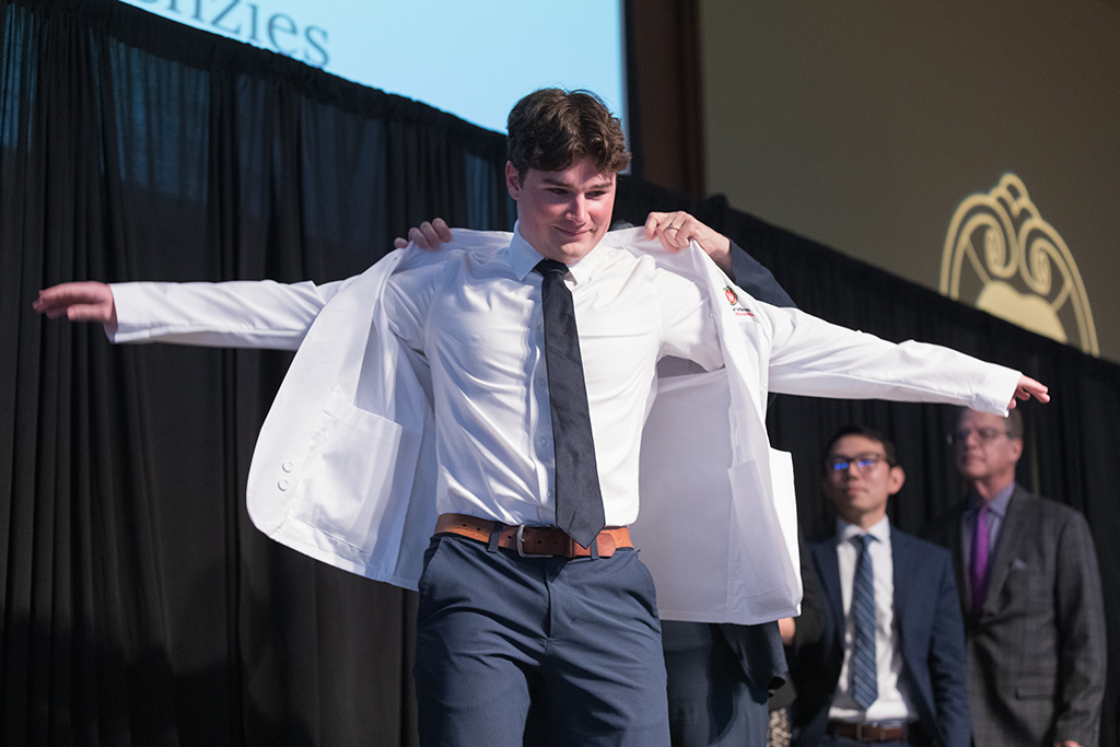 A student receives a white coat during the 2022 White Coat Ceremony.