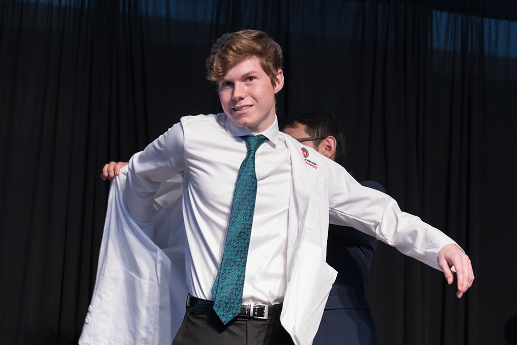 A student receives a white coat during the 2022 White Coat Ceremony.