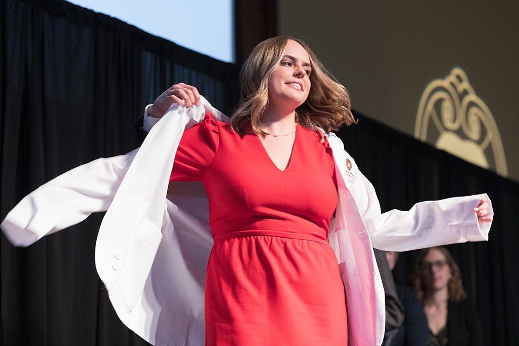 A student receives a white coat during the 2022 White Coat Ceremony.