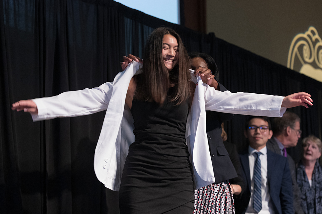 A student receives a white coat during the 2022 White Coat Ceremony.