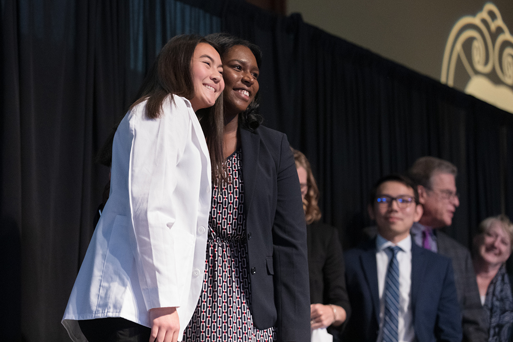 A student receives a white coat during the 2022 White Coat Ceremony.