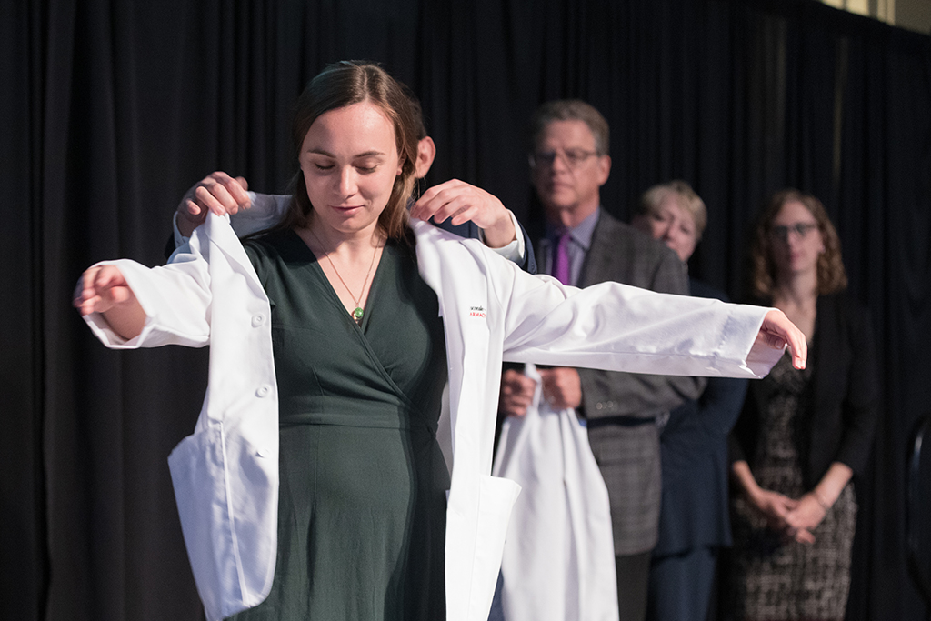 A student receives a white coat during the 2022 White Coat Ceremony.