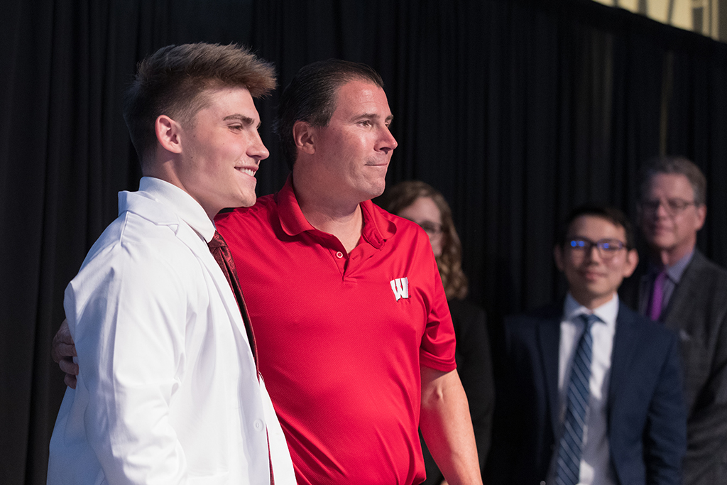 A student receives a white coat during the 2022 White Coat Ceremony.