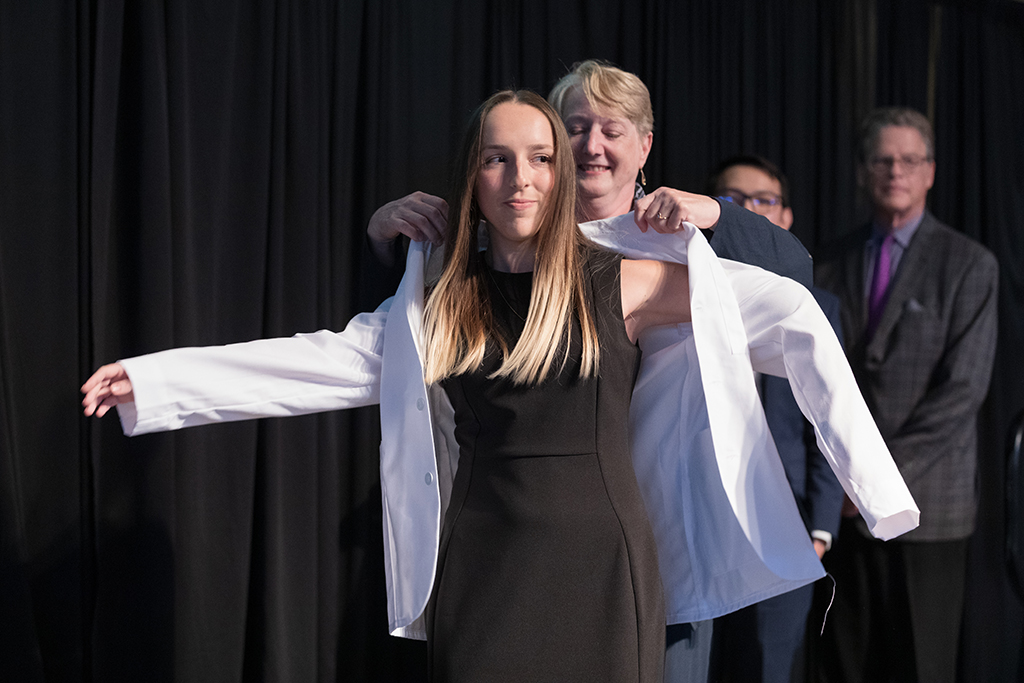 A student receives a white coat during the 2022 White Coat Ceremony.