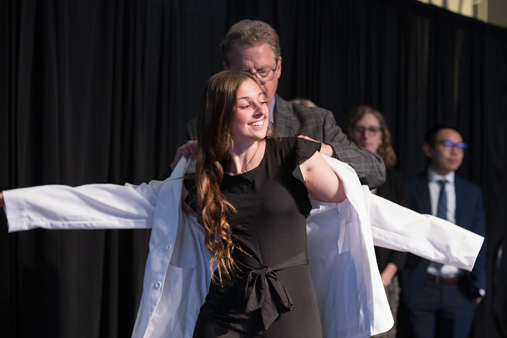 A student receives a white coat during the 2022 White Coat Ceremony.