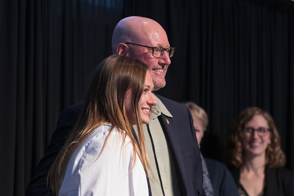 A student receives a white coat during the 2022 White Coat Ceremony.