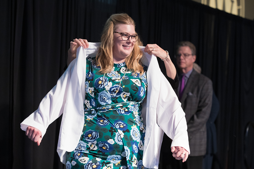 A student receives a white coat during the 2022 White Coat Ceremony.