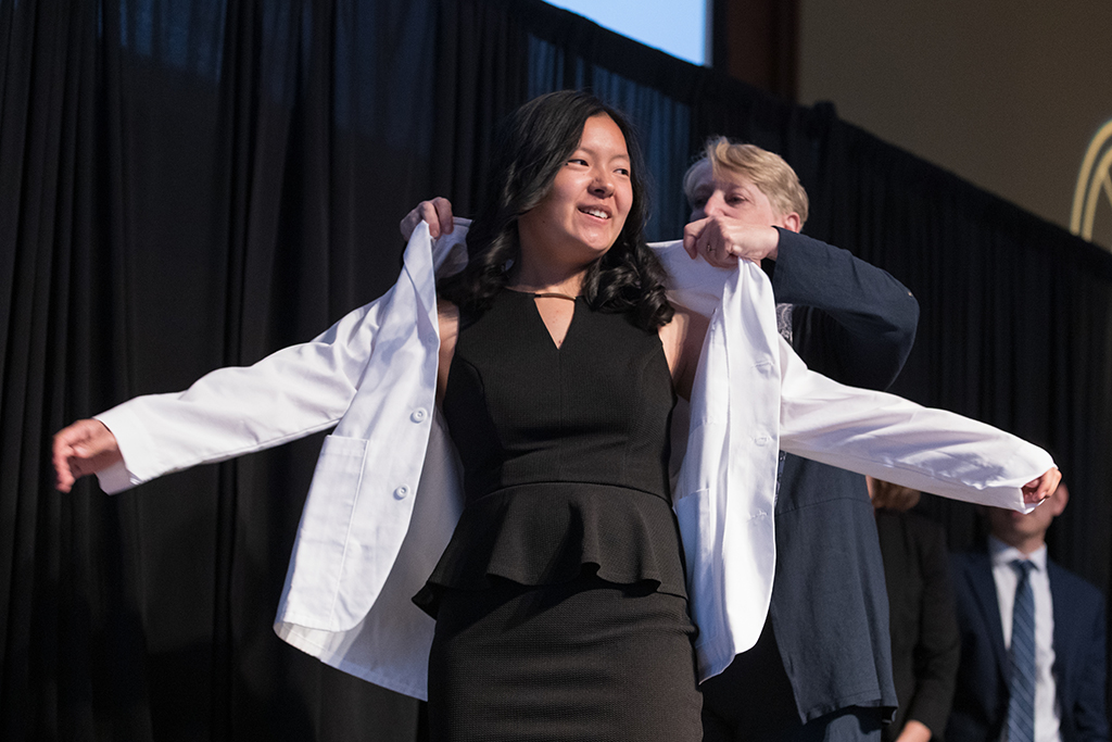 A student receives a white coat during the 2022 White Coat Ceremony.