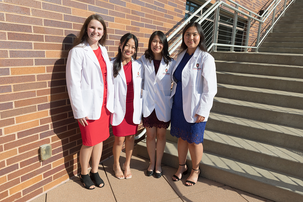 A group of students pose outside after the 2022 White Coat Ceremony.