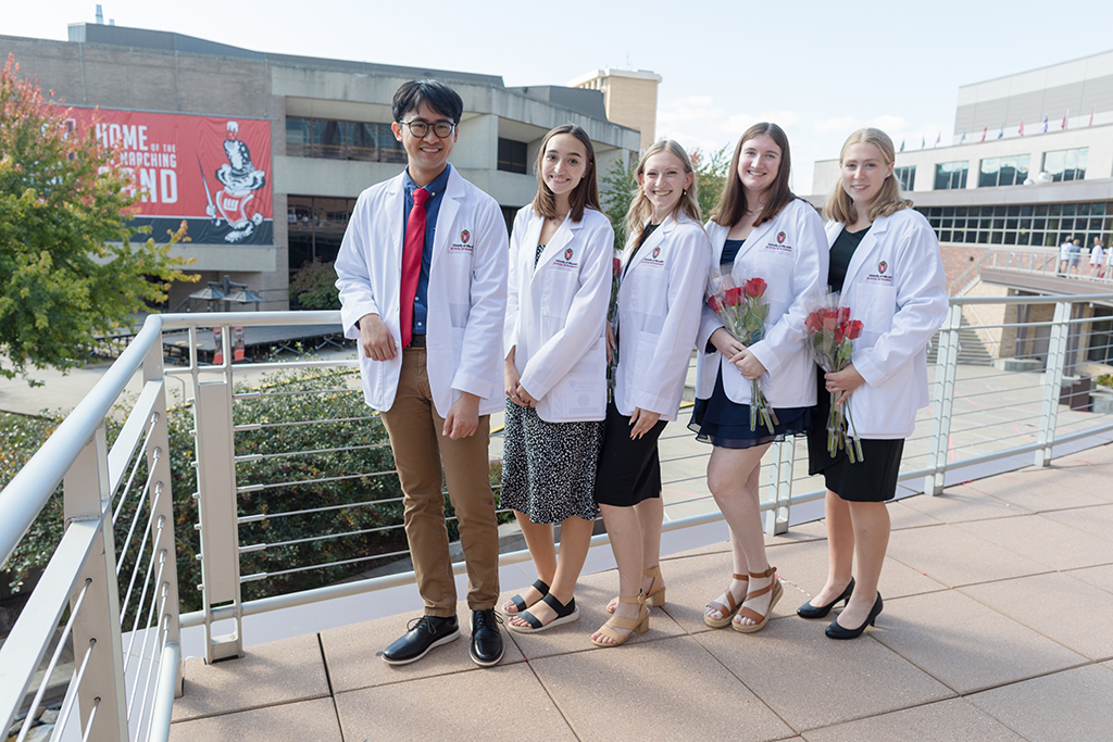 A group of students pose outside after the 2022 White Coat Ceremony.