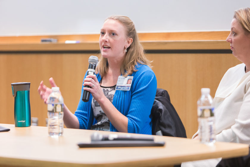 PharmD professional speaking into microphone during career development day