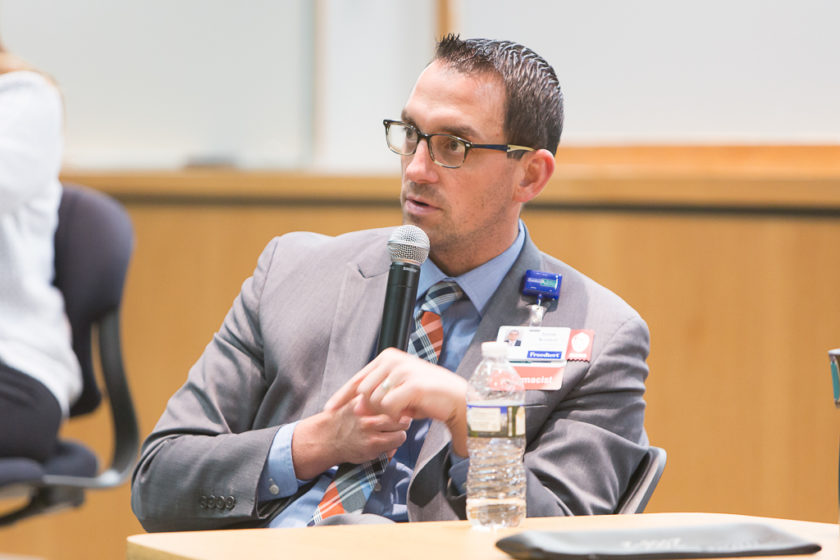 Pharmacist speaking into microphone at career development day