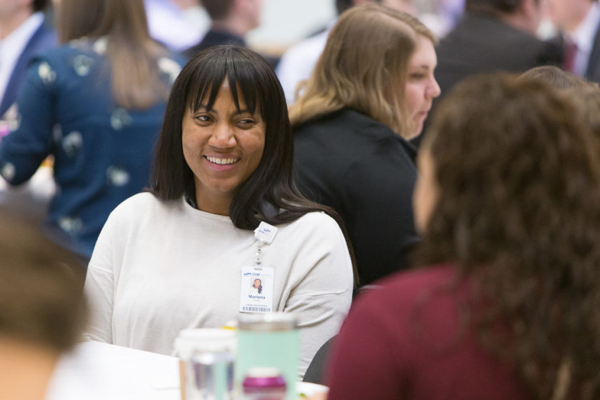 Staff sitting at tables during career development day