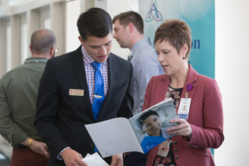 Staff looking through Ascension magazine