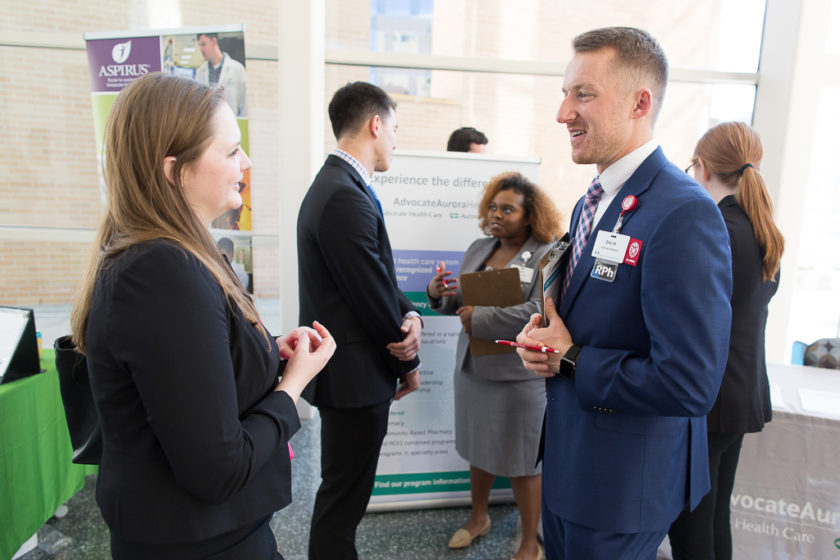 Student speaking to staff at Career development day